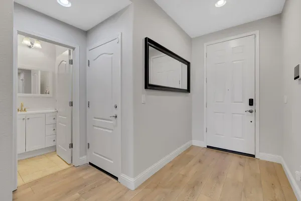 a view of a hallway with wooden floor
