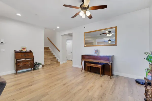 a view of room with wooden floor and windows