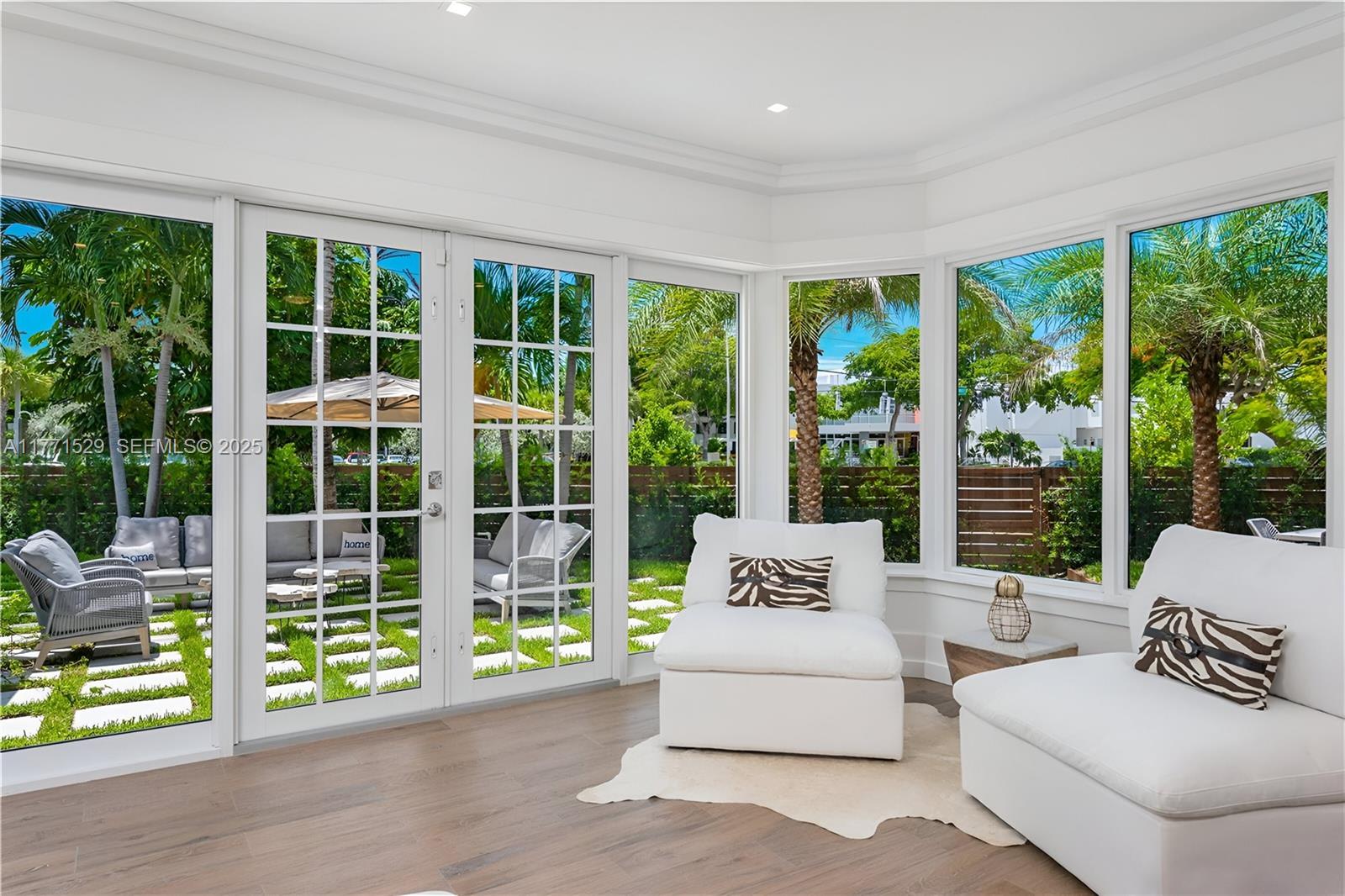 2575 Pine Tree Drive Miami Beach, FL 33140 - Photo 12 of 36 a living room with furniture and windows