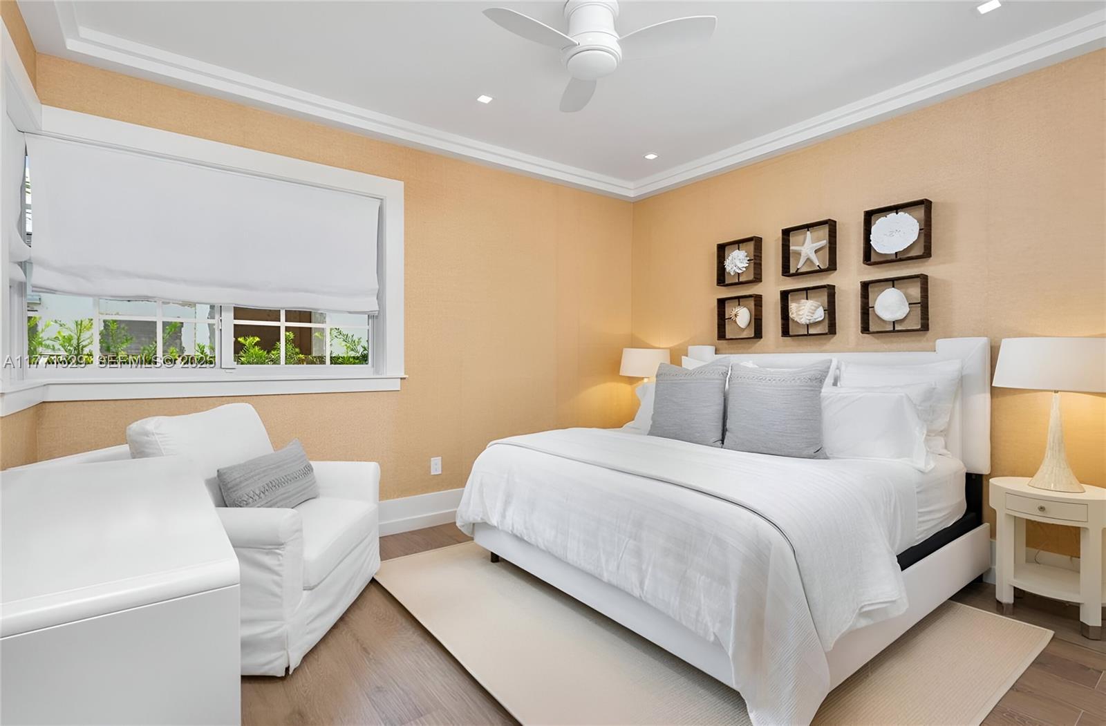 2575 Pine Tree Drive Miami Beach, FL 33140 - Photo 21 of 36 a bedroom with a large bed and a couch