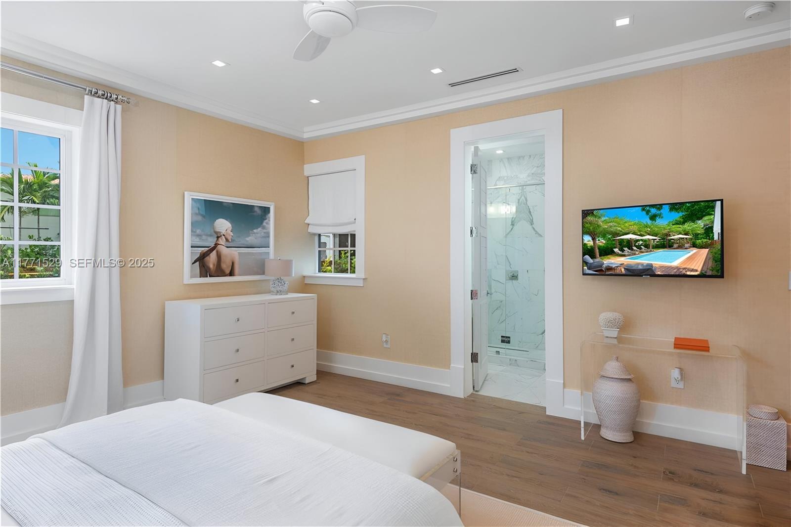 2575 Pine Tree Drive Miami Beach, FL 33140 - Photo 22 of 36 a bedroom with a bed and a view of bathroom