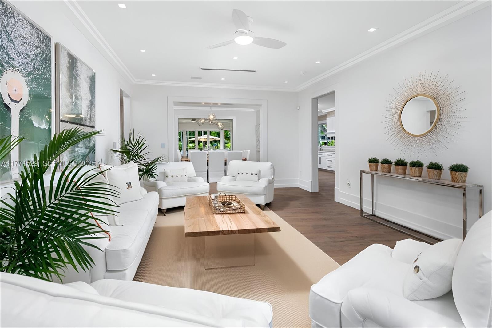 2575 Pine Tree Drive Miami Beach, FL 33140 - Photo 4 of 36 a living room with furniture and a large window