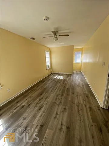 a view of a room with wooden floor