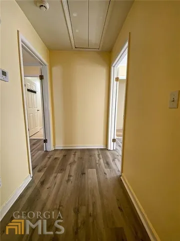 an empty room with wooden floor and a window