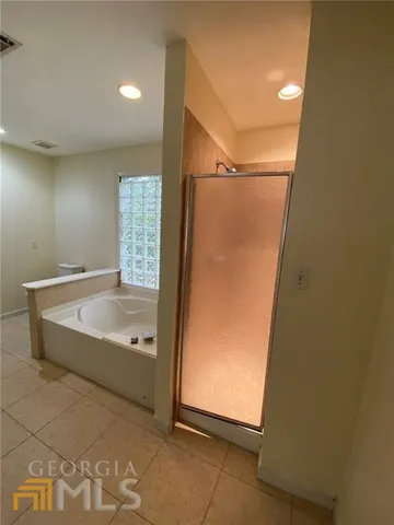 a bathroom with a bathtub and shower