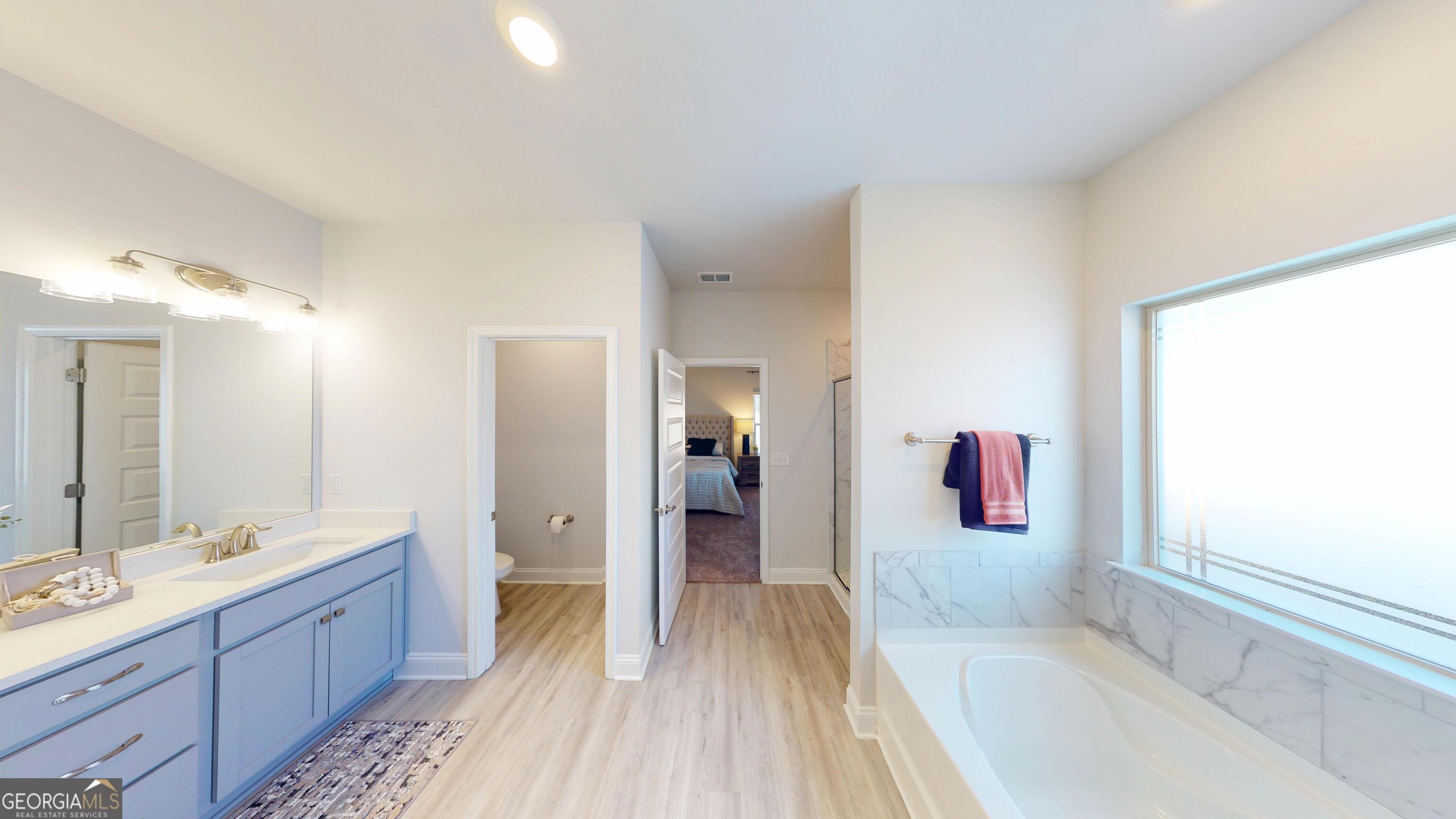 1007 Holiday Pass Griffin, GA 30223 - Photo 13 of 22 a spacious bathroom with a tub sink and mirror