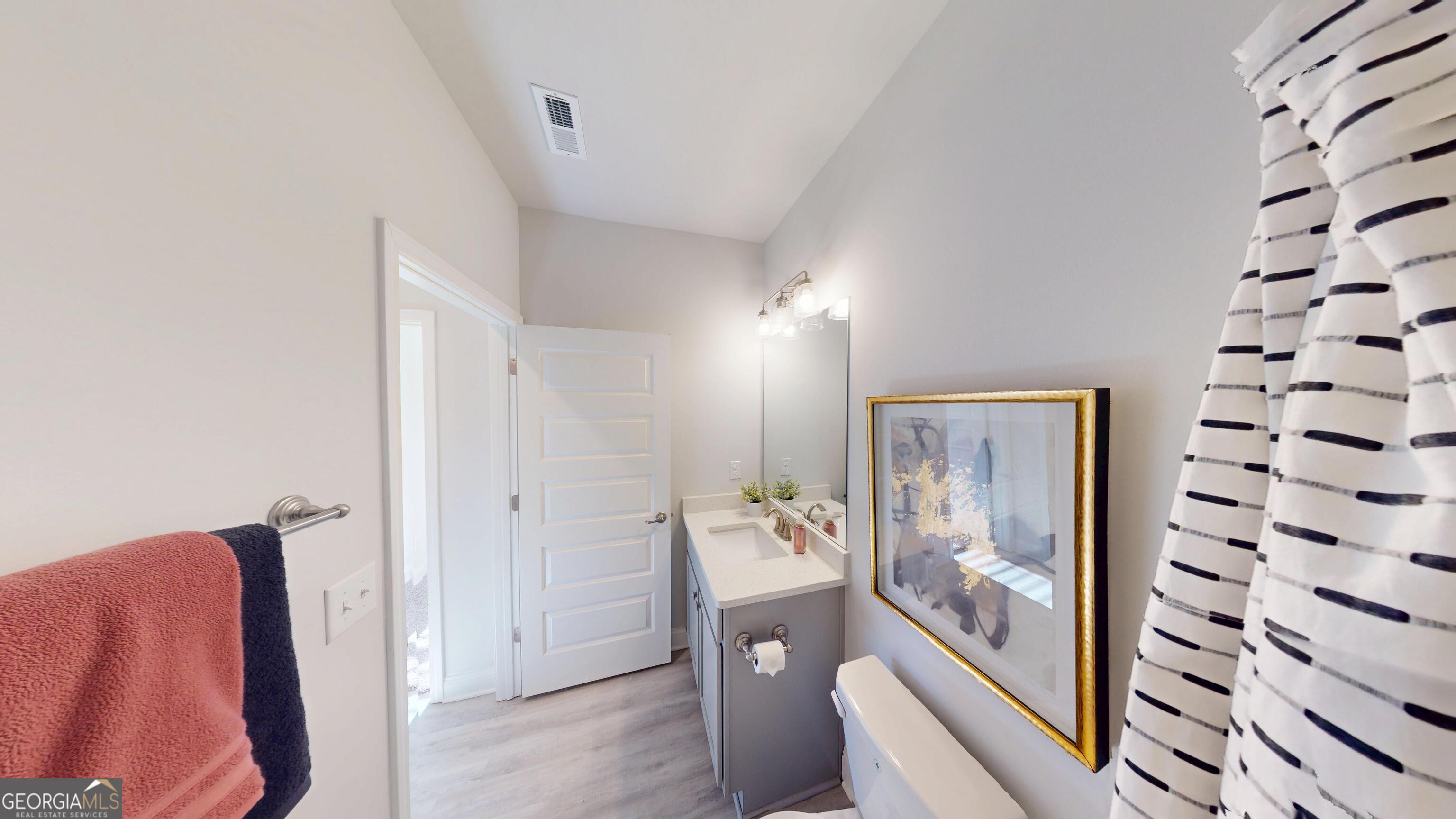 1007 Holiday Pass Griffin, GA 30223 - Photo 18 of 22 a view of hallway with furniture and wooden floor