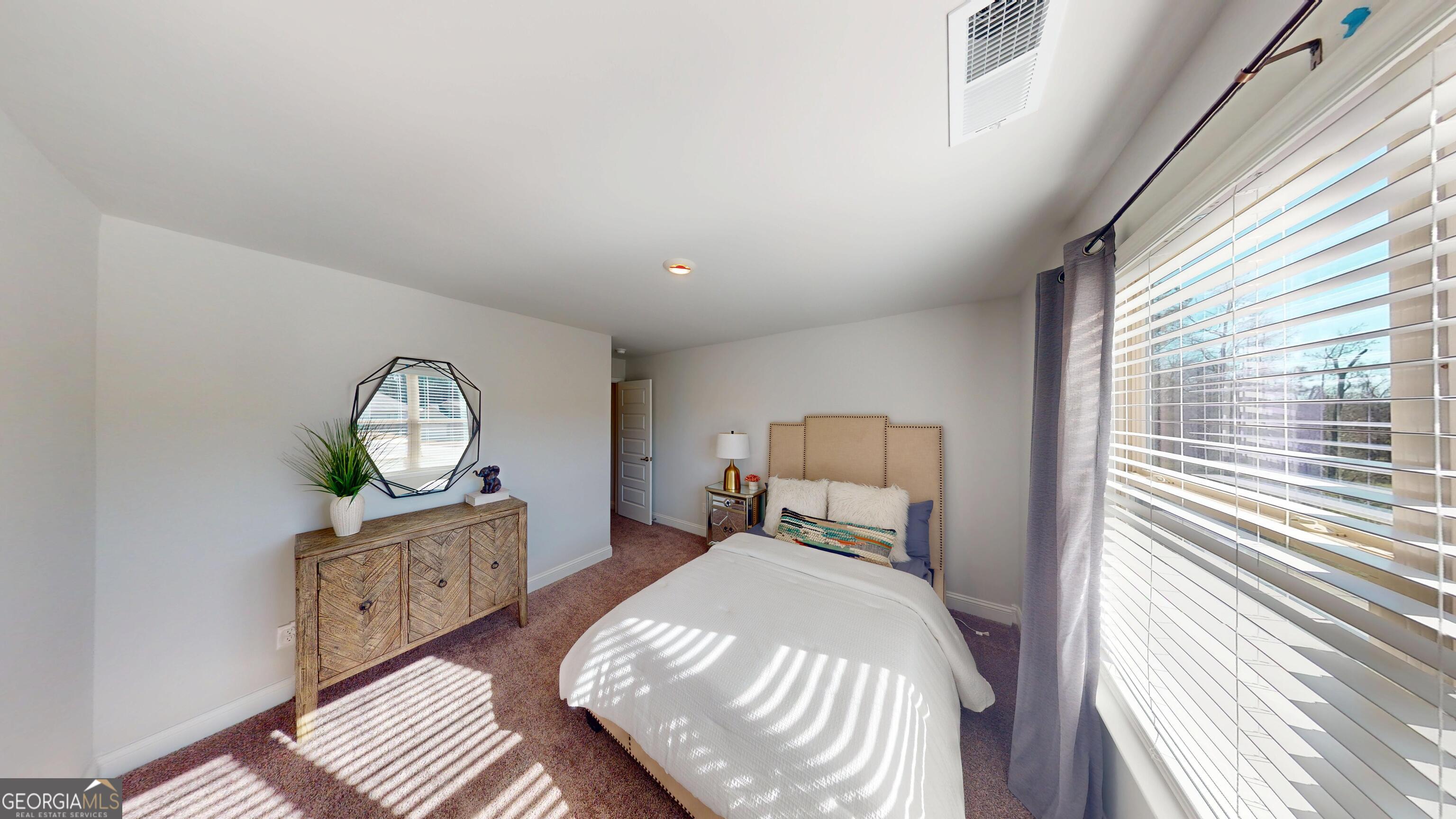 1007 Holiday Pass Griffin, GA 30223 - Photo 22 of 22 a bedroom with a large bed and a window