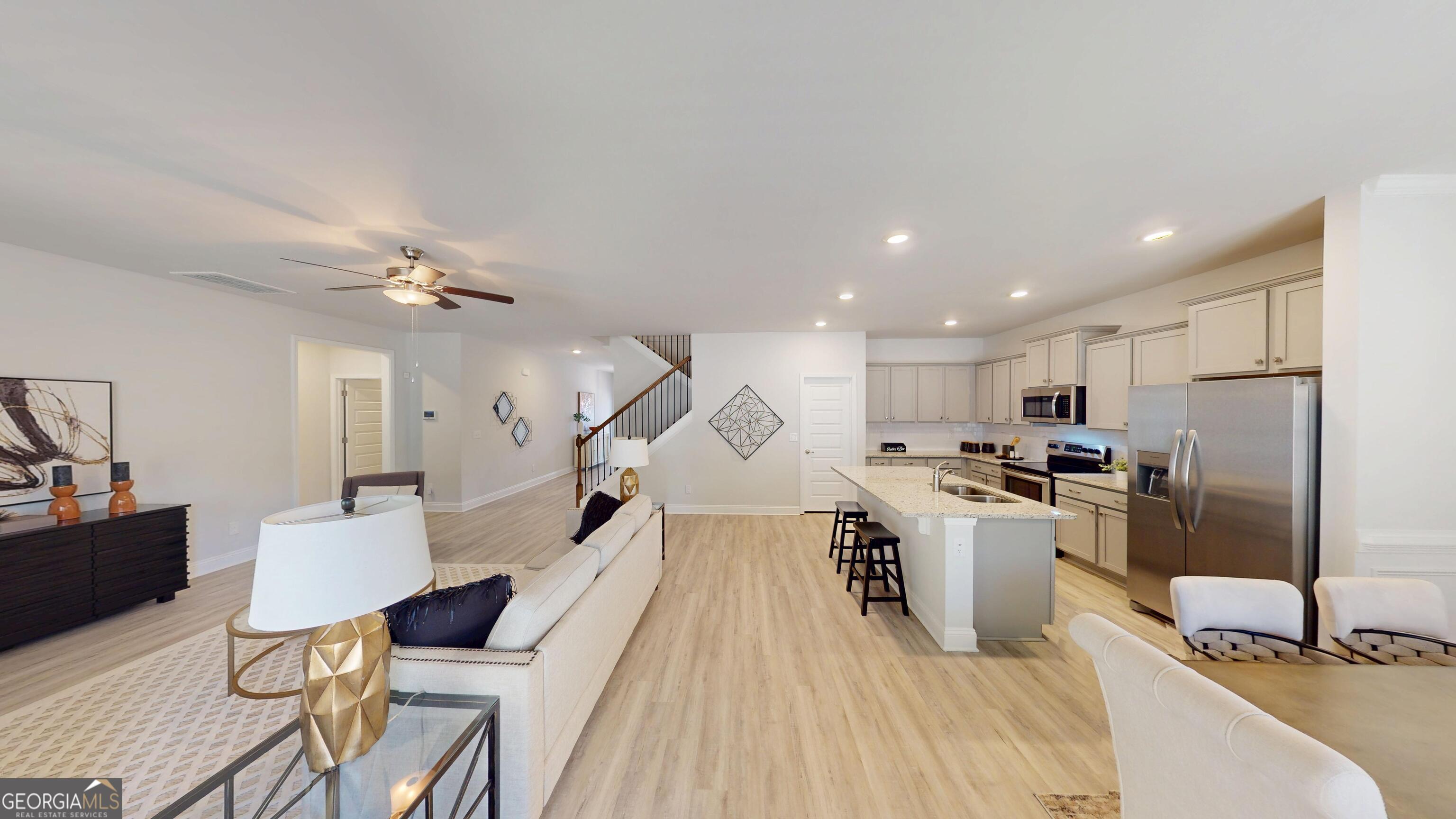 1007 Holiday Pass Griffin, GA 30223 - Photo 4 of 22 a living room with stainless steel appliances furniture and a kitchen view