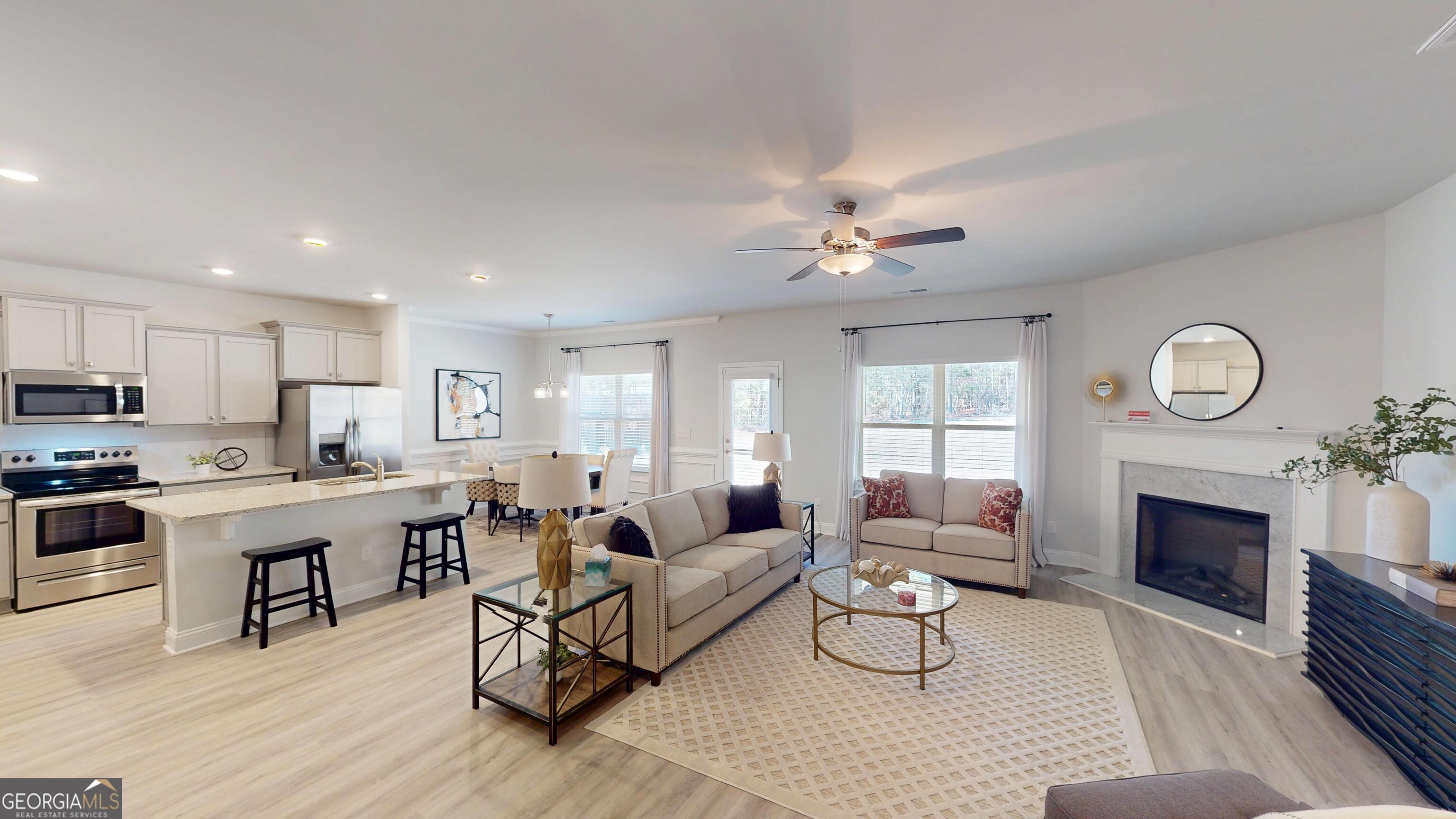 1007 Holiday Pass Griffin, GA 30223 - Photo 5 of 22 a living room with furniture a fireplace a rug and a window