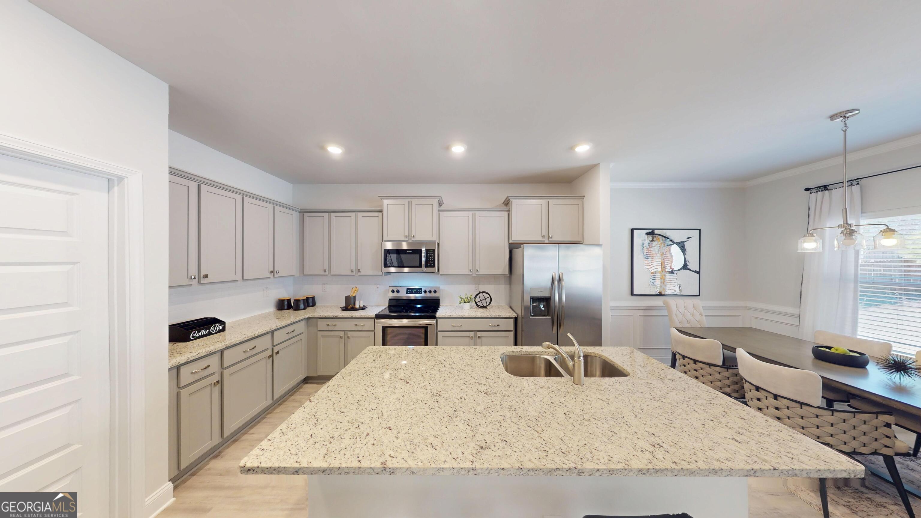 1007 Holiday Pass Griffin, GA 30223 - Photo 6 of 22 a kitchen with stainless steel appliances granite countertop a sink stove and refrigerator