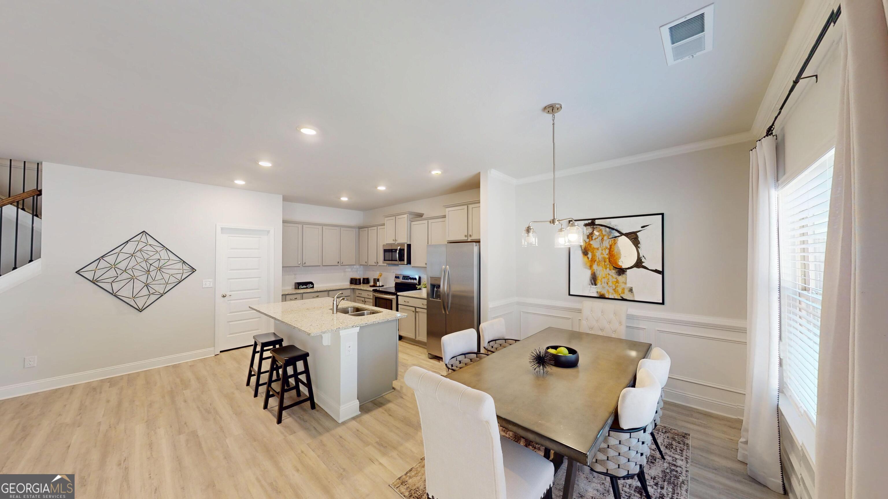 1007 Holiday Pass Griffin, GA 30223 - Photo 7 of 22 a kitchen with stainless steel appliances kitchen island granite countertop a sink and a refrigerator