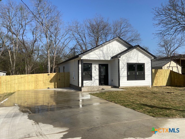 608 North Cedar Avenue Luling, TX 78648 - Photo 1 of 1 a view of a house with a big yard and large tree