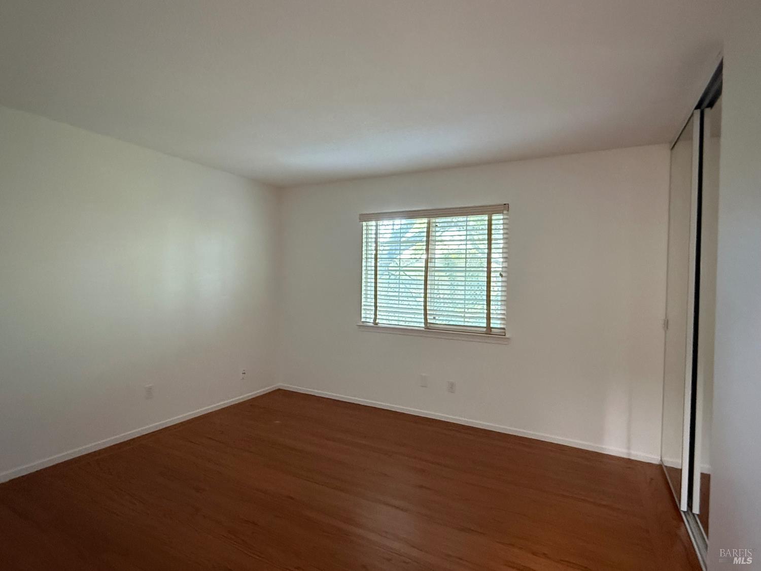 2553 Cactus Avenue Santa Rosa, CA 95405 - Photo 9 of 15 an empty room with wooden floor and windows