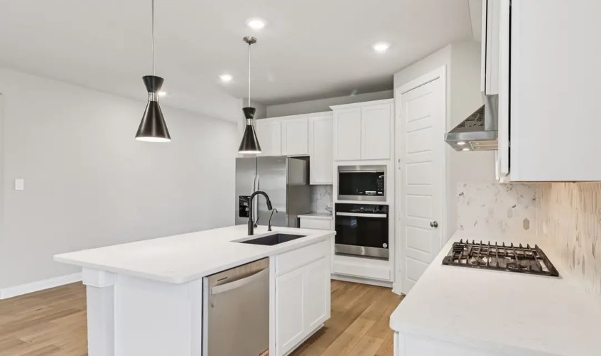 212 Raine Manor Montgomery, TX 77316 - Photo 2 of 12 a kitchen with a white stove top oven and refrigerator