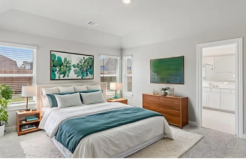 212 Raine Manor Montgomery, TX 77316 - Photo 4 of 12 a bedroom with a bed and a flat screen tv