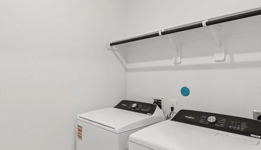 212 Raine Manor Montgomery, TX 77316 - Photo 9 of 12 a utility room with dryer and washer