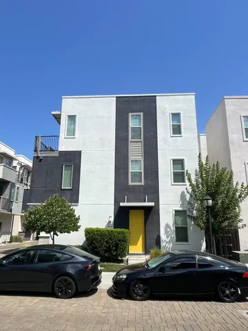 a view of a door of the house with a small garden