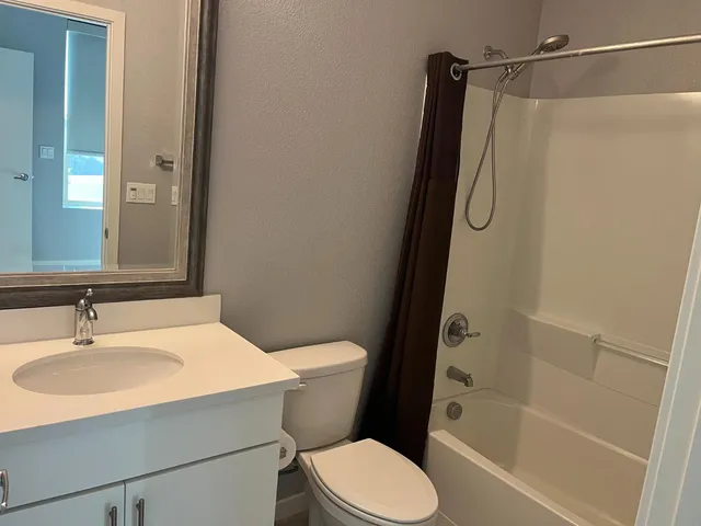 a kitchen with a refrigerator and a sink