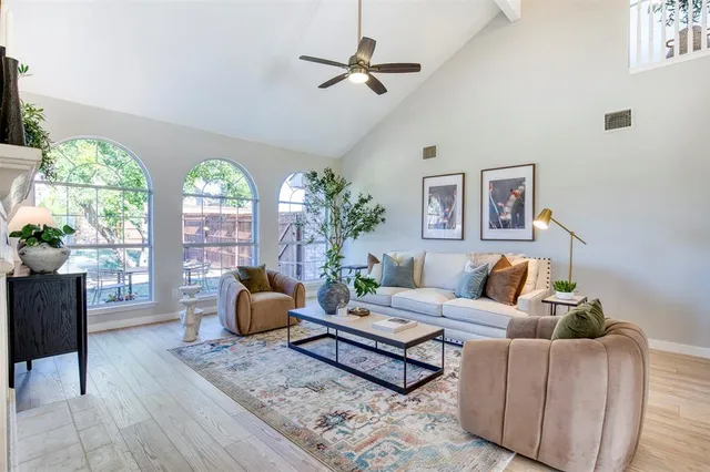 a living room with furniture a chandelier and a window