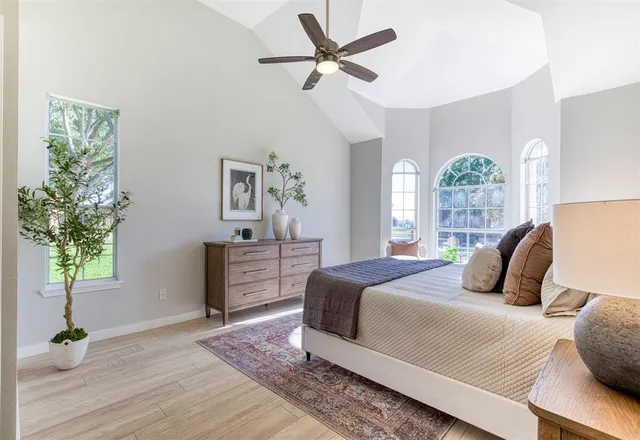 a bedroom with a bed dresser and a window