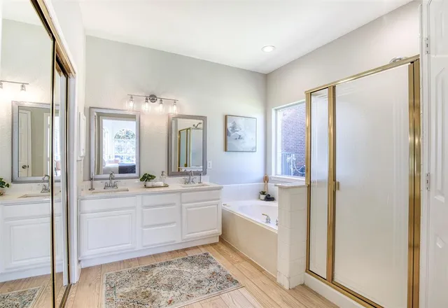 a large bathroom with a double vanity sink mirror and