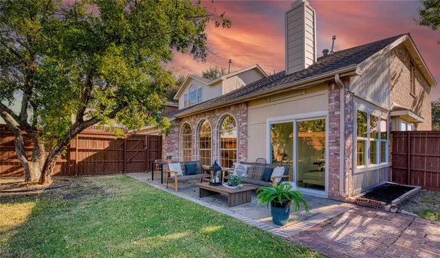 a view of a house with backyard sitting area and garden