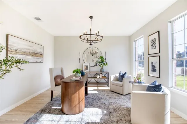 a living room with furniture a chandelier and a window