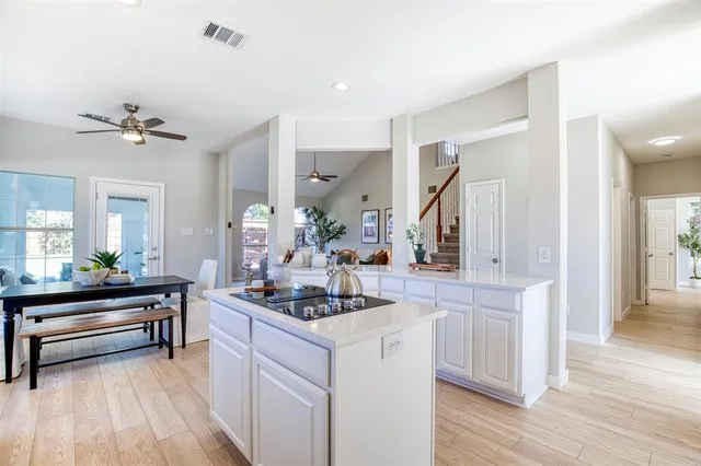a kitchen with a sink cabinets and wooden floor