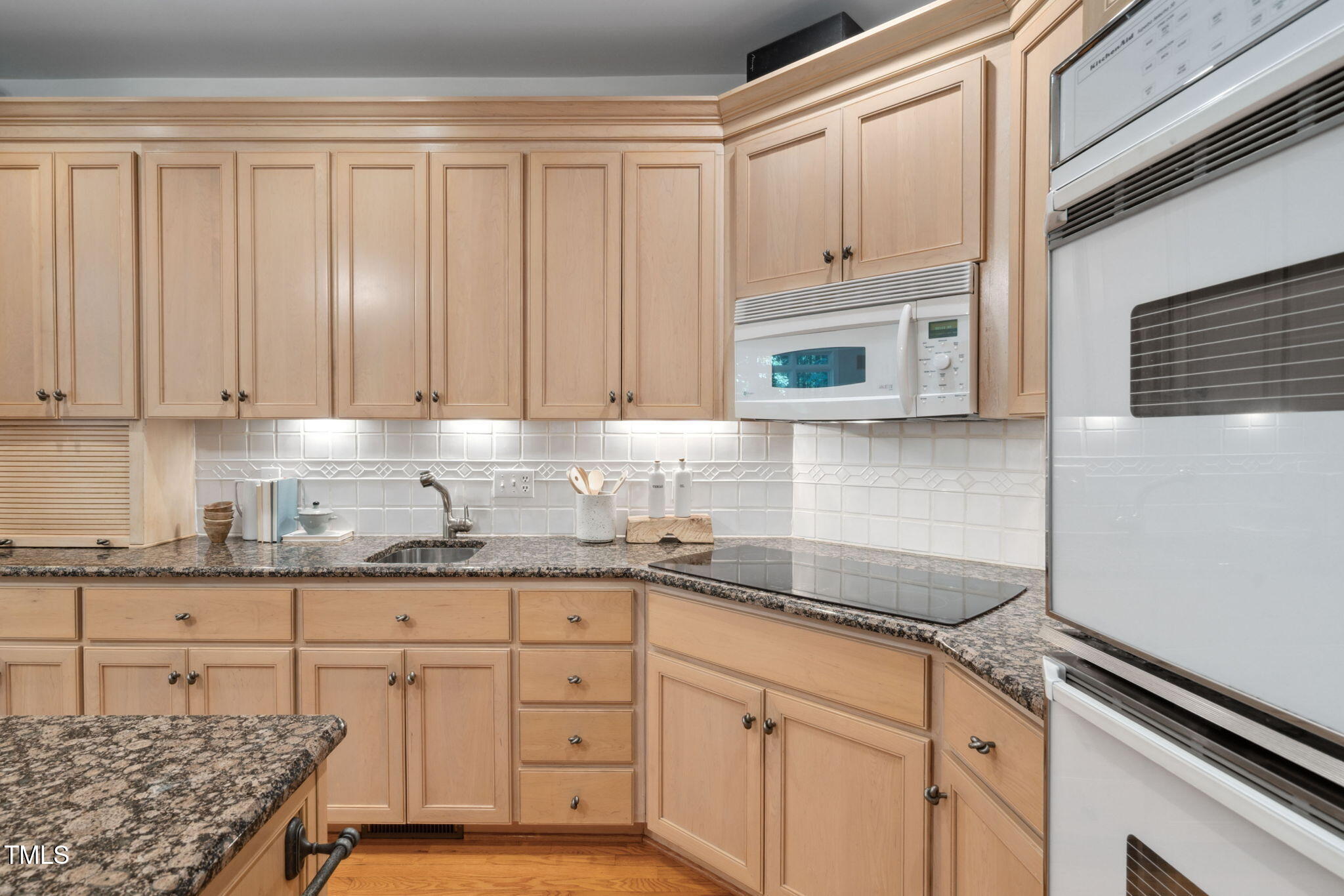 10405 Veasey Mill Road Raleigh, NC 27615 - Photo 13 of 94 a kitchen with granite countertop white cabinets and stainless steel appliances