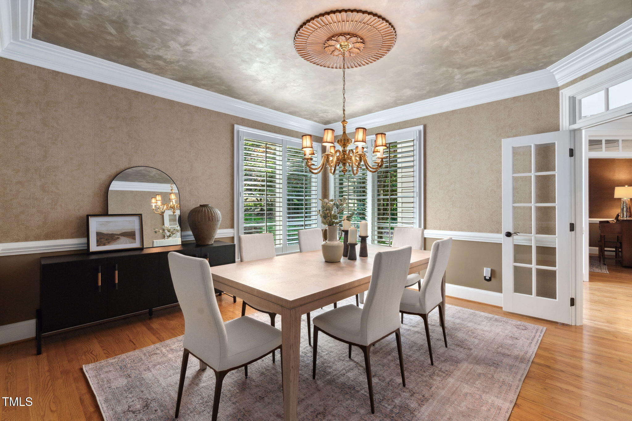 10405 Veasey Mill Road Raleigh, NC 27615 - Photo 14 of 94 a view of a dining room with furniture wooden floor and chandelier
