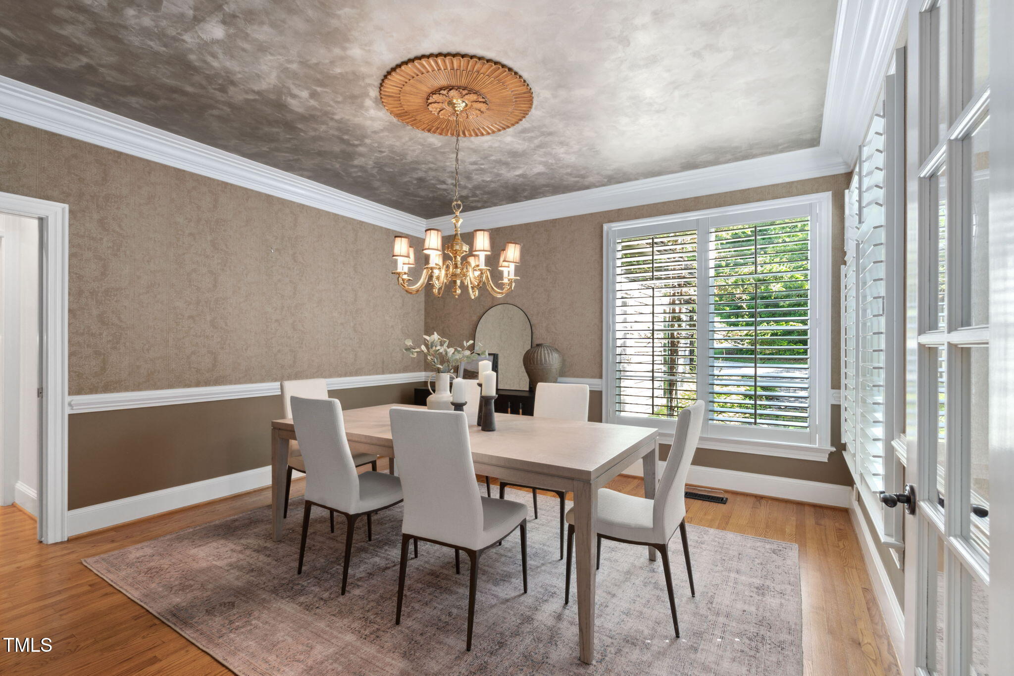 10405 Veasey Mill Road Raleigh, NC 27615 - Photo 15 of 94 a view of a dining room with furniture wooden floor and chandelier