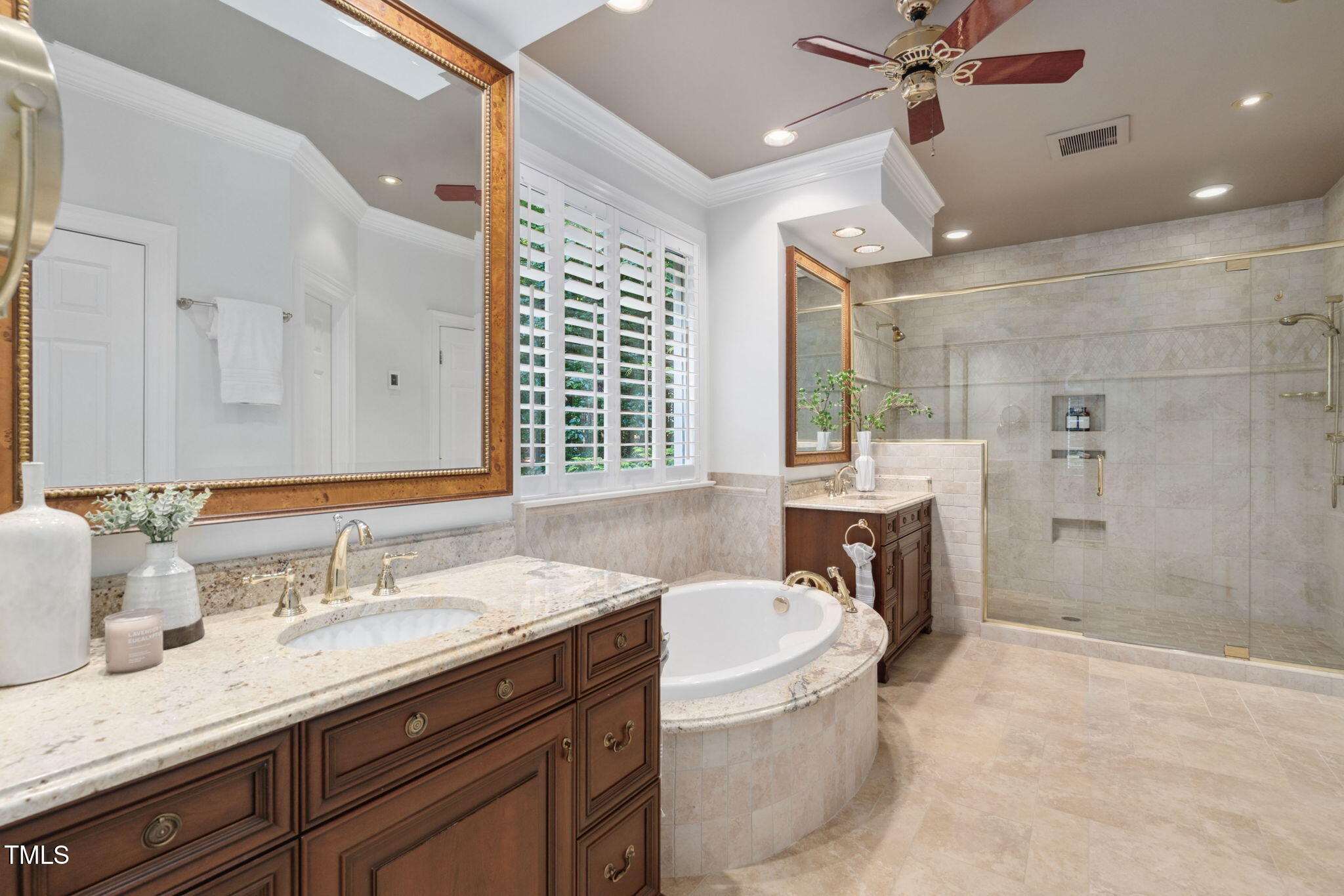 10405 Veasey Mill Road Raleigh, NC 27615 - Photo 31 of 94 a bathroom with a granite countertop sink a mirror a bathtub and a shower