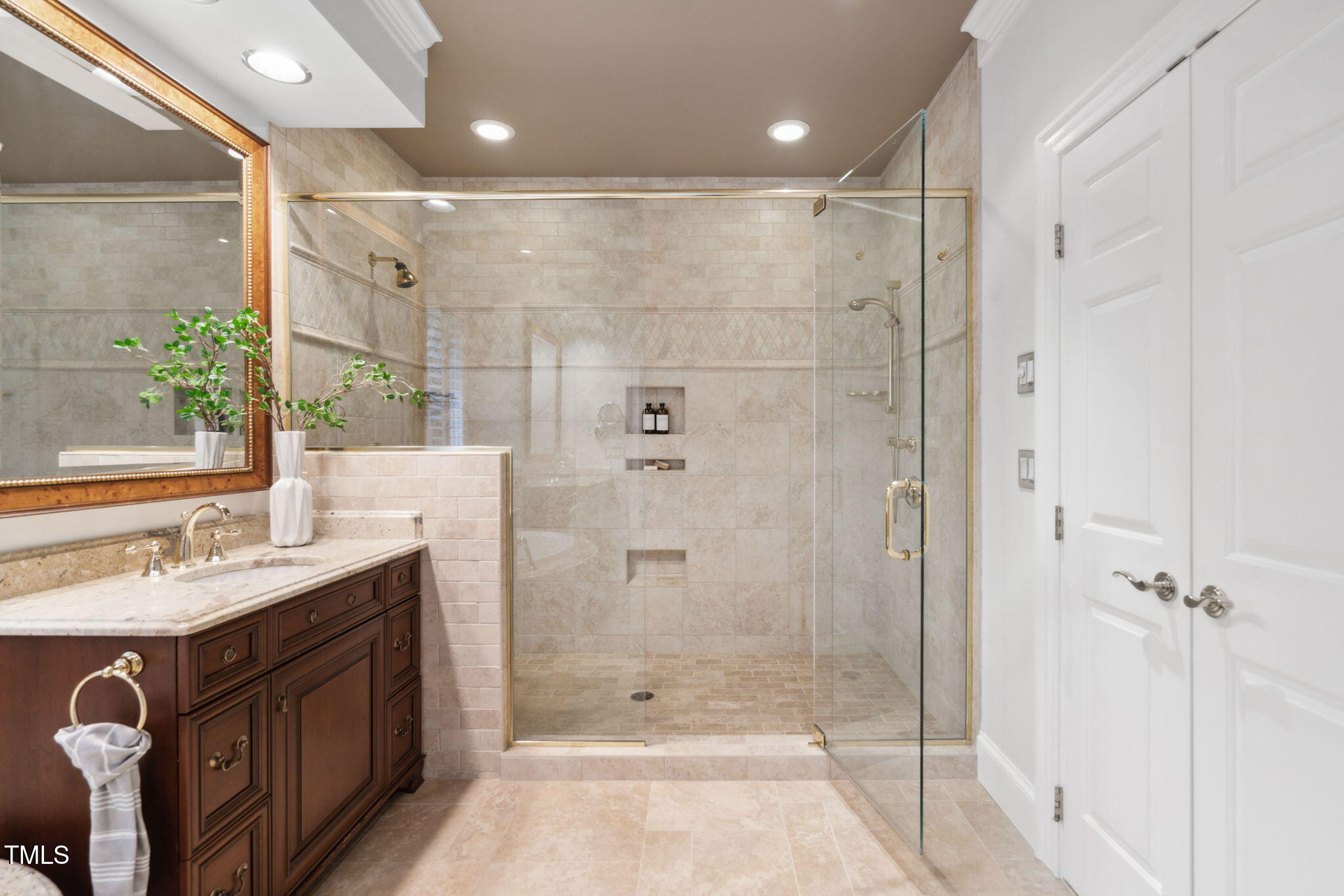 10405 Veasey Mill Road Raleigh, NC 27615 - Photo 32 of 94 a bathroom with a double vanity sink toilet and shower