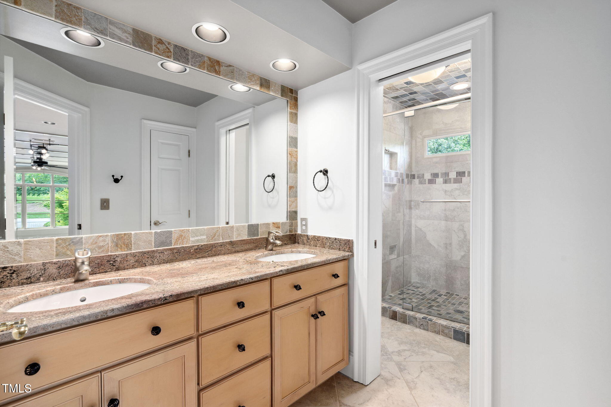 10405 Veasey Mill Road Raleigh, NC 27615 - Photo 35 of 94 a bathroom with a granite countertop sink mirror and double