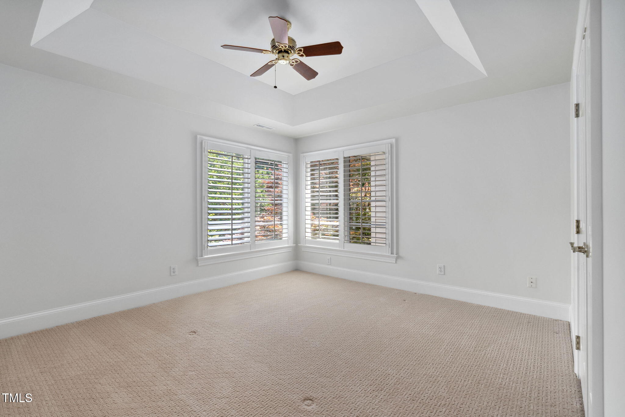 10405 Veasey Mill Road Raleigh, NC 27615 - Photo 39 of 94 an empty room with ceiling fan and windows