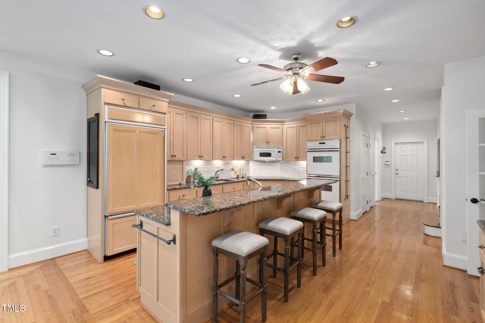 10405 Veasey Mill Road Raleigh, NC 27615 - Photo 9 of 94 a kitchen with stainless steel appliances granite countertop furniture wooden floor and a refrigerator