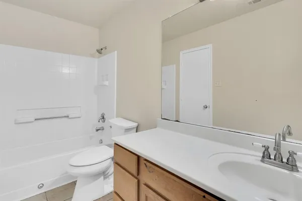 a bathroom with a sink toilet vanity and shower