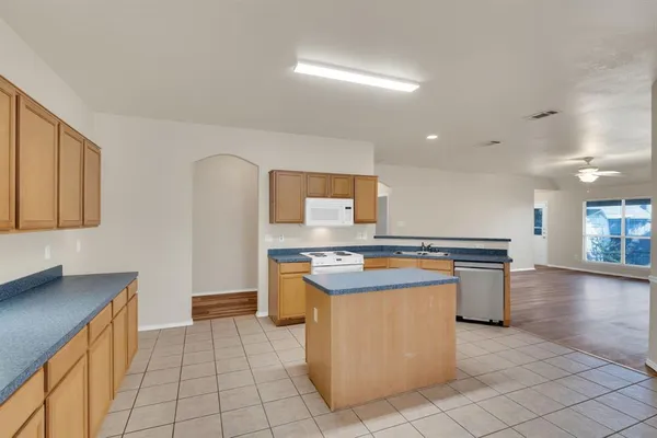 a kitchen with a stove sink and cabinets