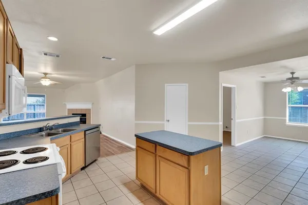 a kitchen with a stove top oven and cabinets