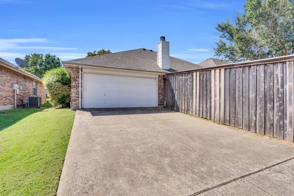 a front view of a house with a garden and yard