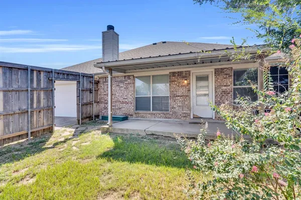 a front view of a house with a garden and plants