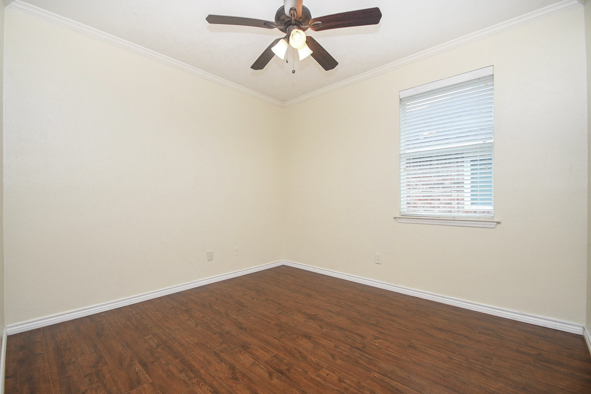 5602 Walkabout Way Katy, TX 77450 - Photo 26 of 33 an empty room with wooden floor ceiling fan and windows