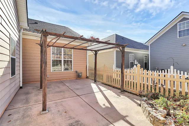 a view of a house with wooden fence