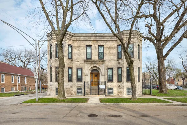 a front view of a residential apartment building with a yard