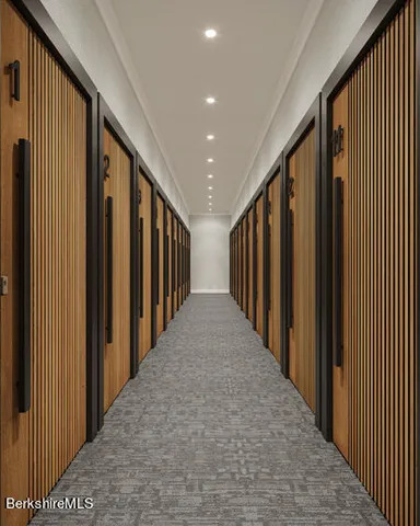 a view of a hallway with wooden stairs