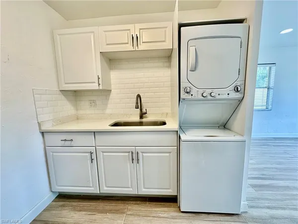 a kitchen with sink cabinets and a wooden floor