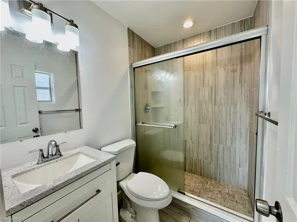 a bathroom with a sink toilet and shower