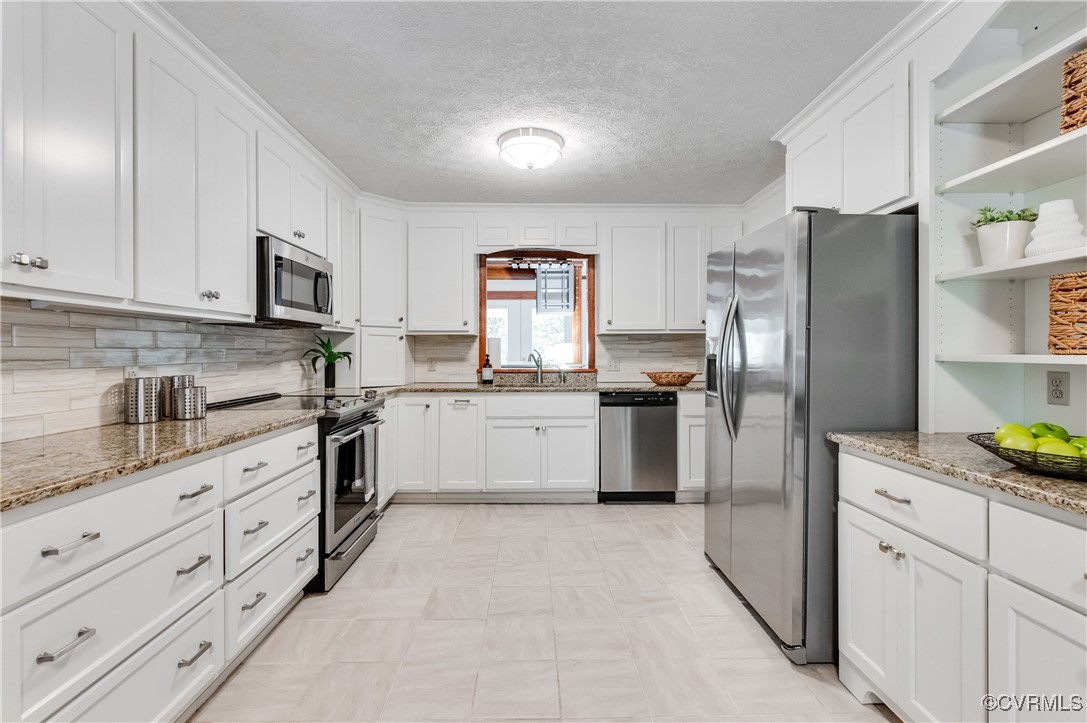 13321 Hensley Road Chesterfield, VA 23832 - Photo 11 of 48 a kitchen with granite countertop white cabinets and stainless steel appliances