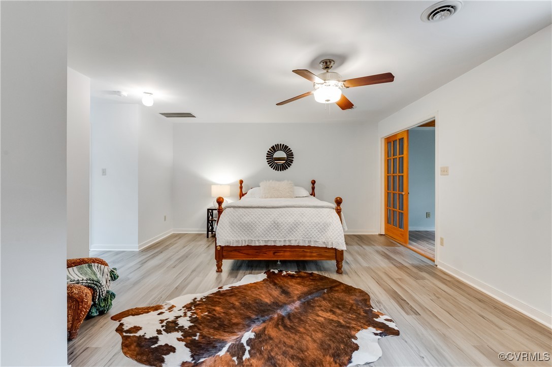 13321 Hensley Road Chesterfield, VA 23832 - Photo 21 of 48 a bedroom with a bed and wooden floor